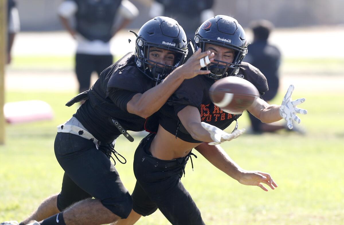 Los Amigos defensive back Adolfo Chavez, left, covers wide receiver Joshua Barriga during practice on Friday.