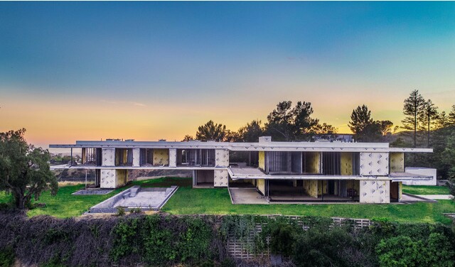 The four-acre promontory estate includes a modern mansion, guesthouse, guard house, swimming pool and tennis court.