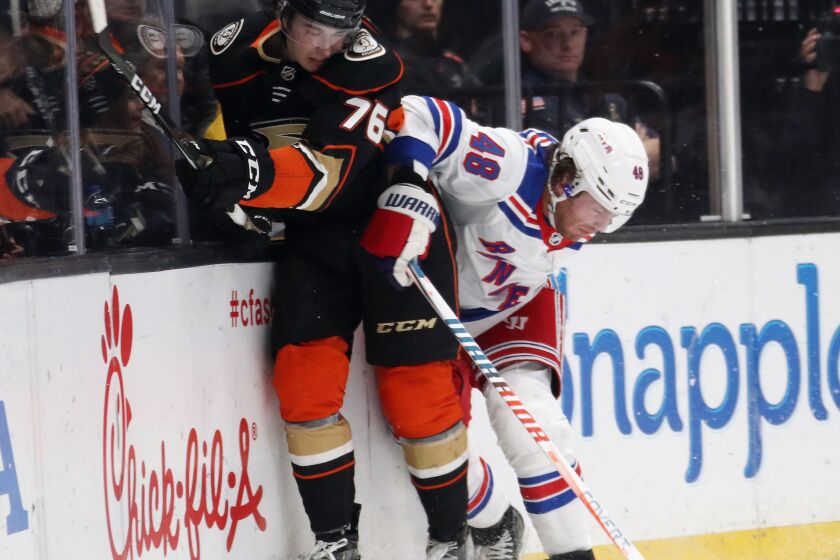 ANAHEIM, CALIFORNIA - DECEMBER 14: Josh Mahura #76 of the Anaheim Ducks is checked by Brendan Lemieux #48 of the New York Rangers during the second period at the Honda Center on December 14, 2019 in Anaheim, California. (Photo by Bruce Bennett/Getty Images) ** OUTS - ELSENT, FPG, CM - OUTS * NM, PH, VA if sourced by CT, LA or MoD **
