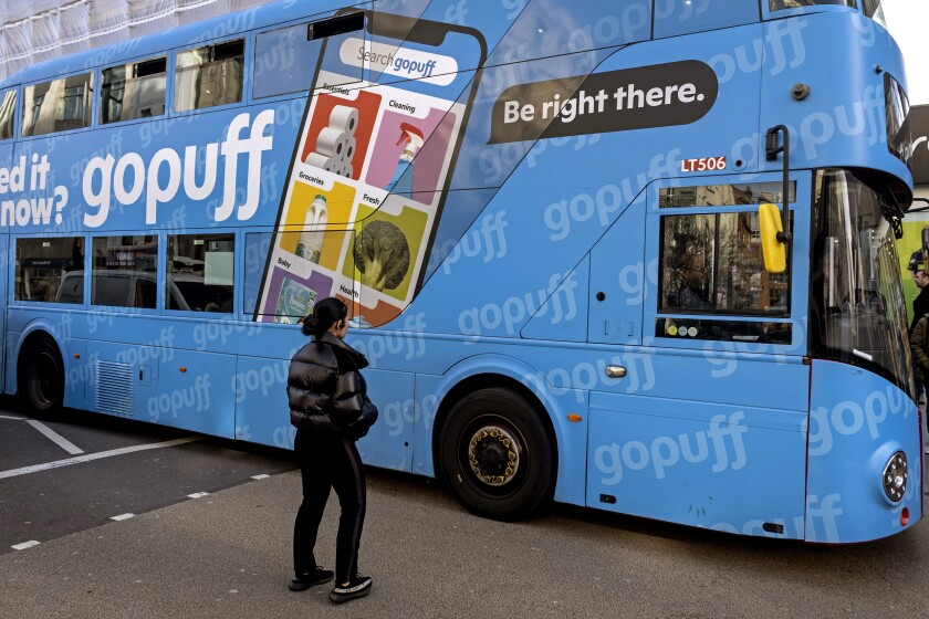 A bus advertisement for Gopuff grocery and delivery store in London.