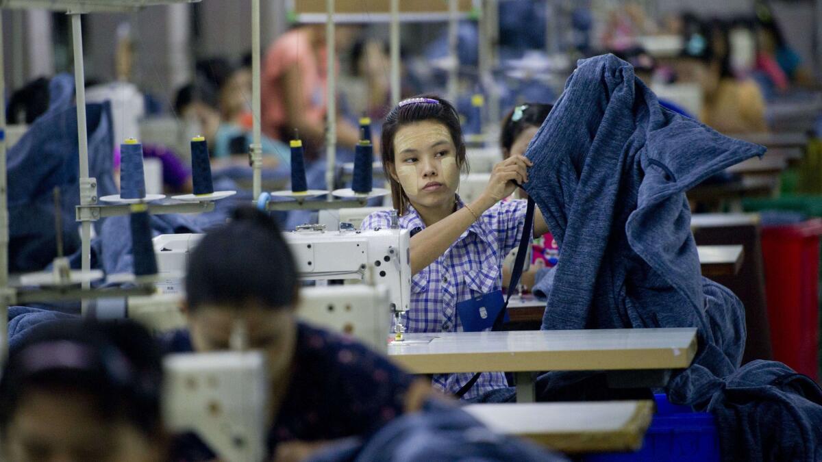 Employees work at the Shweyi Zabe garment factory in Yangon, Myanmar. Foreign investors see opportunities to develop Myanmar's garment industry.