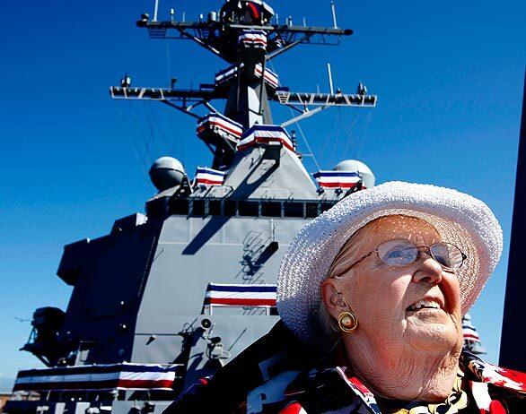Sybil Stockdale, the widow of Vice Adm. James Stockdale, sits on the bow of the missile destroyer Stockdale, named in her husband's honor, shortly before the commissioning ceremony for the new warship at Naval Base Ventura County in Port Hueneme.