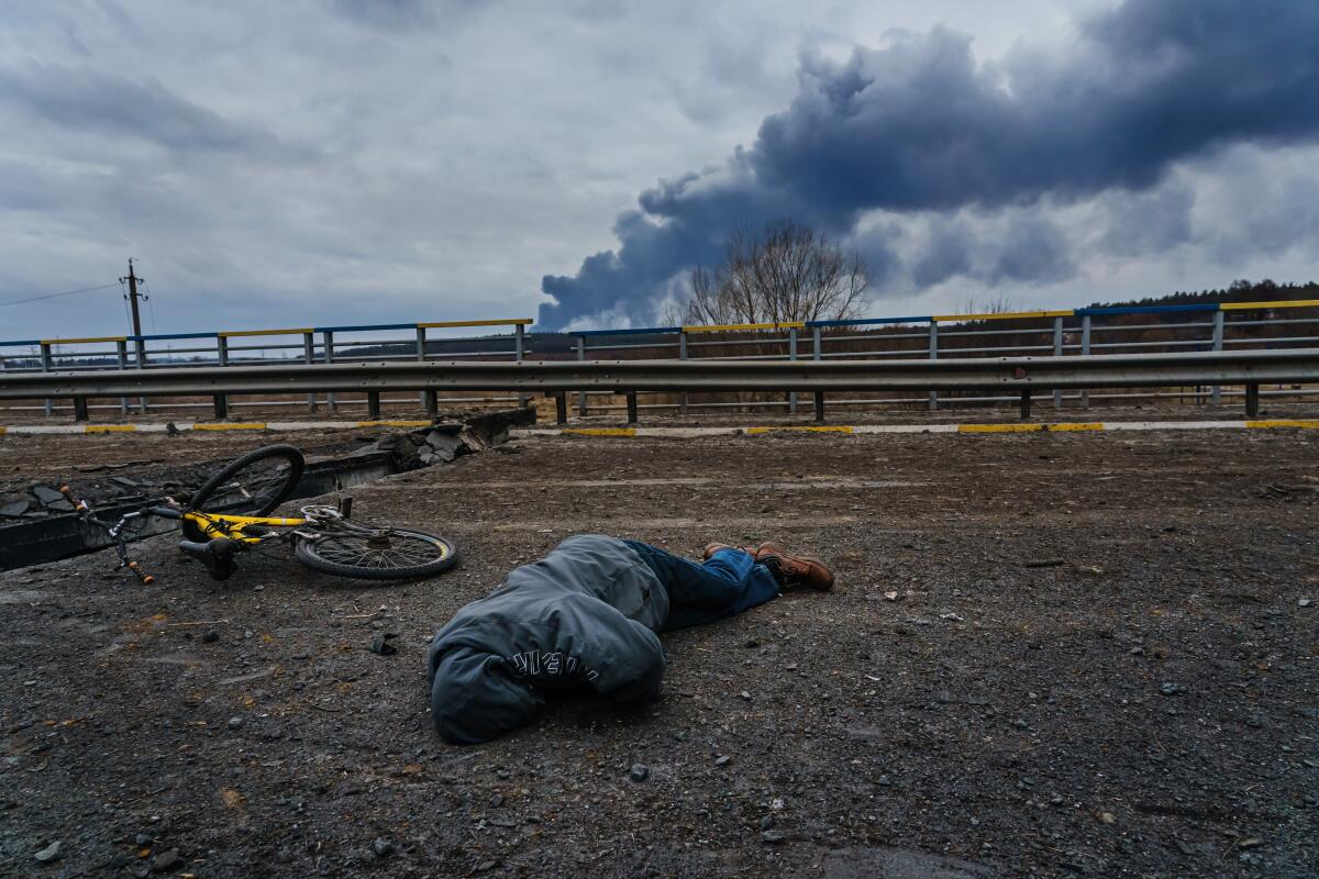 The body of a civilian on a destroyed bridge overlooking the Irpin River in Irpin, Ukraine.