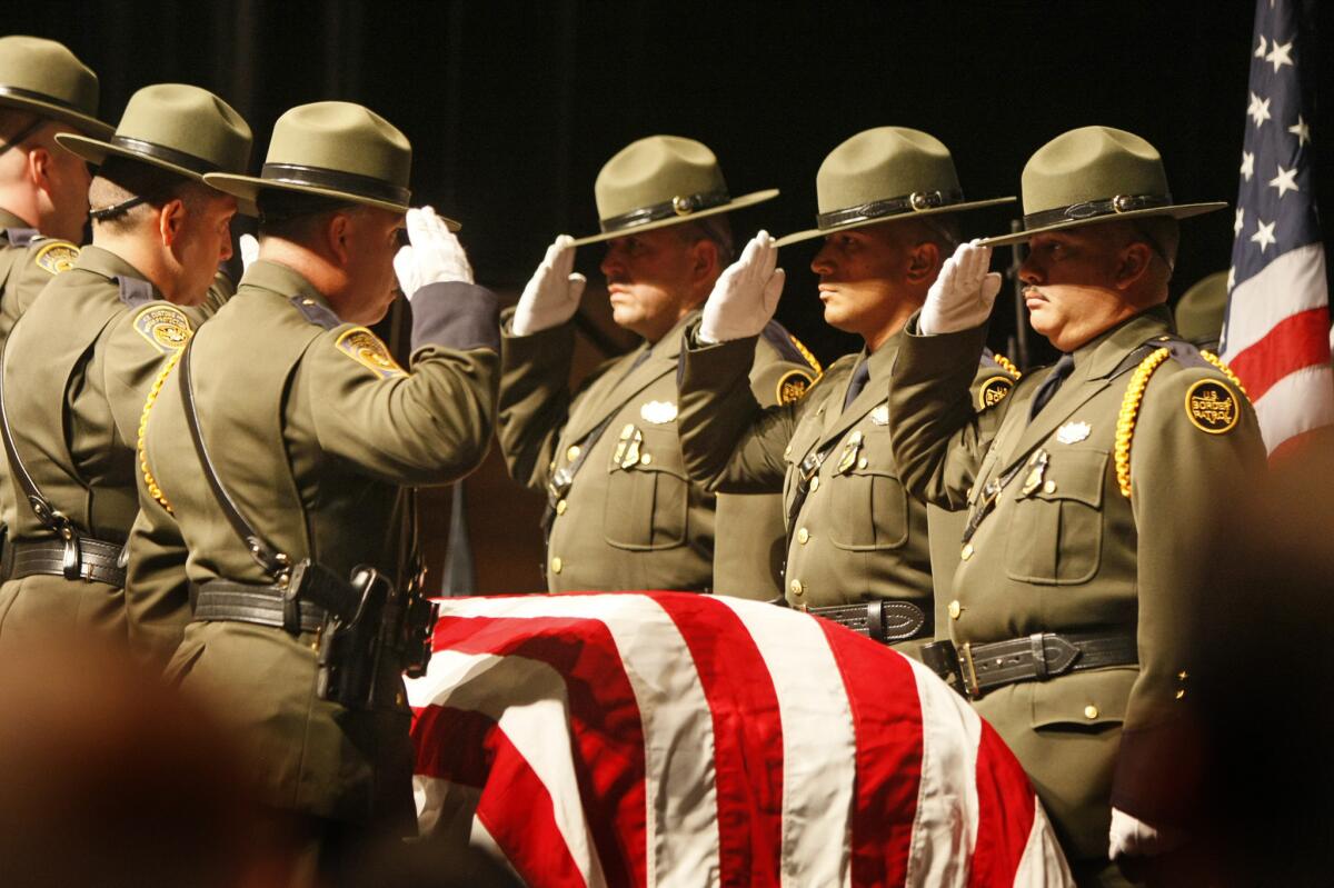 A Border Patrol honor guard stands at attention and salutes before agent Robert Rosas' flag-draped coffin during a memorial in El Centro for the fallen agent in 2009. Three of his killers have now been sentenced to prison.