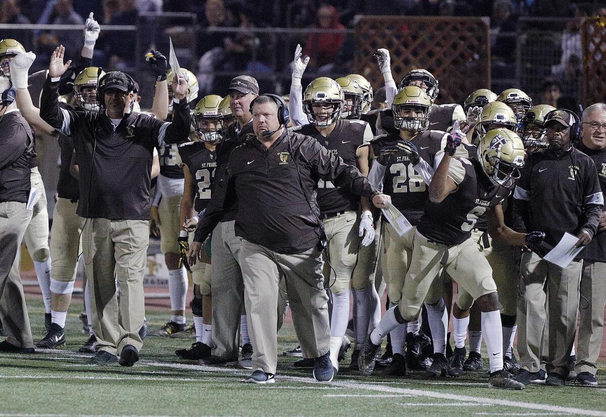 The St. Francis sidelines reacts to scoring against Cathedral, with head coach Jim Bonds in front in an Angelus League boys' football game at St. Francis High School on Friday, November 1, 2019. At halftime, St. Francis was leading 24-0.