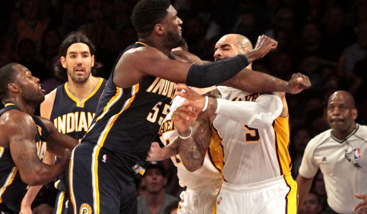 Pacers center Roy Hibbert (55) and Lakers forward Carlos Boozer get into a shoving match in the second half. Hibbert was given a technical foul and Boozer a flagrant foul 1 for starting the incident.