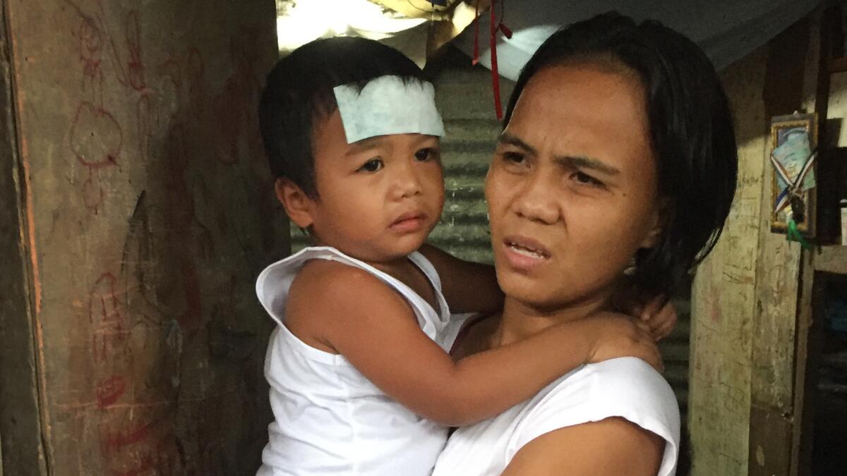 Kathrina Polo, 30, with her 2-year-old son, Marco. Her husband, Cherwen Polo, 38, was shot and killed by Philippine police during an August 2016 raid in Quezon City.