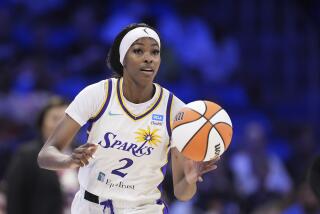 Los Angeles Sparks' Rickea Jackson handles the ball during a WNBA basketball game.