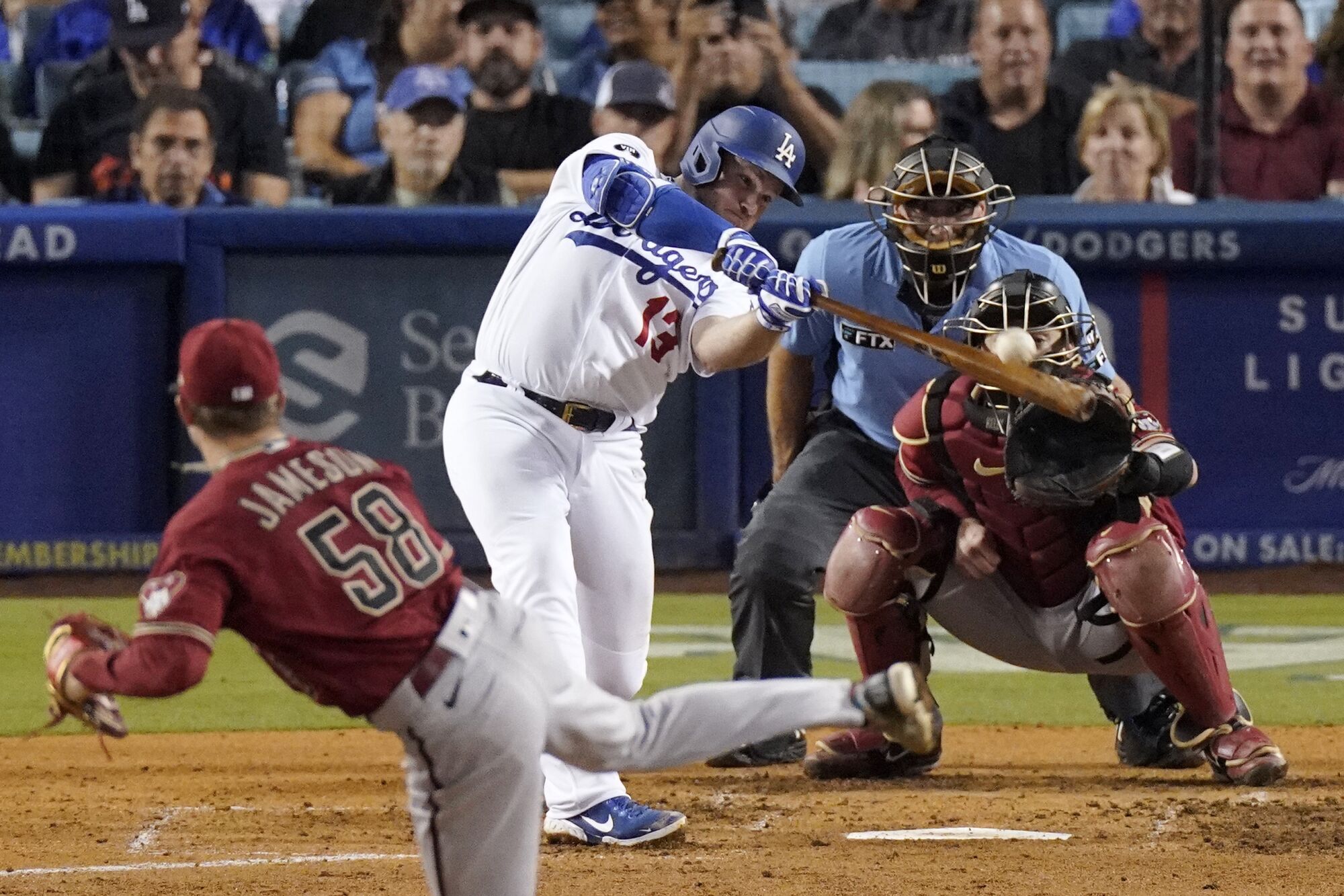 Max Muncy hits a two-run home run against Arizona Diamondbacks reliever Drey Jameson on Sept. 20 at Dodger Stadium.