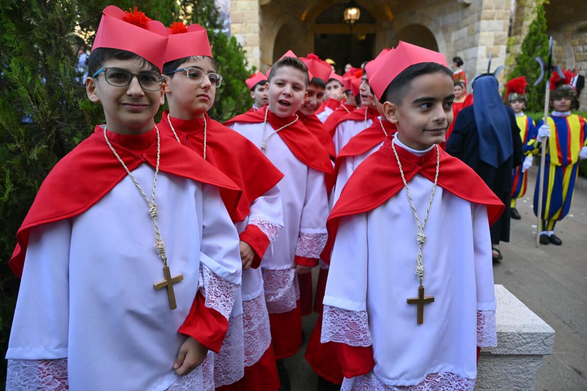 Children dressed as cardinals are pictured outside the Sisters of the Cross Hospital