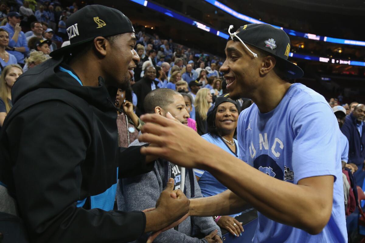 North Carolina forward Brice Johnson celebrates with Villanova's Kris Jenkins after the Tar Heels defeated Notre Dame to advance to the Final Four.