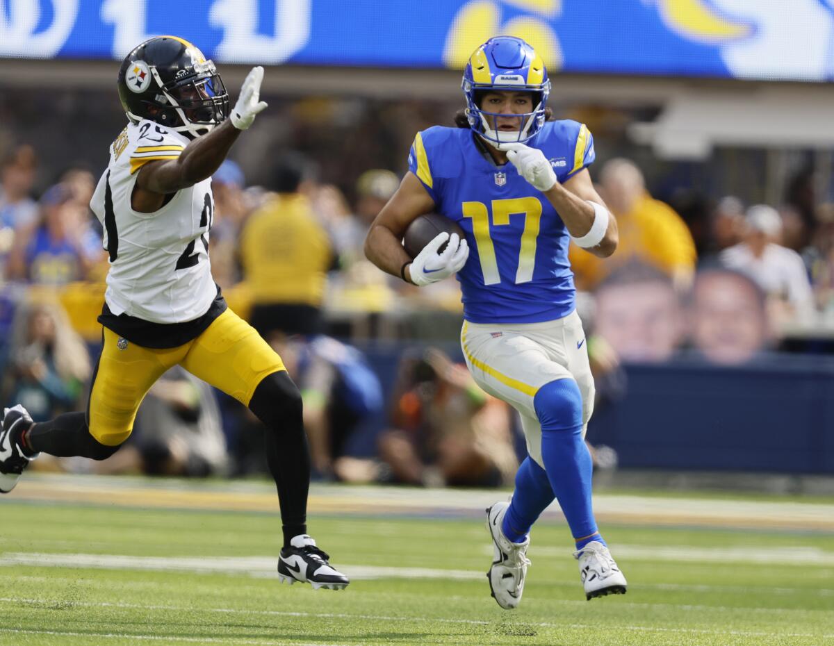The Rams' Puka Nacua runs past the Steelers' Patrick Peterson after a reception.