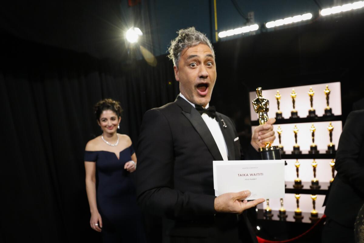 Taika Waititi clutches his adapted screenplay Oscar for “Jojo Rabbit.”