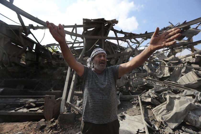 A man reacts at an industrial area destroyed by an Israeli airstrike, in Wadi al-Kfour, Nabatieh province, south Lebanon, Saturday, Aug. 17, 2024.(AP Photo/Mohammed Zaatari)