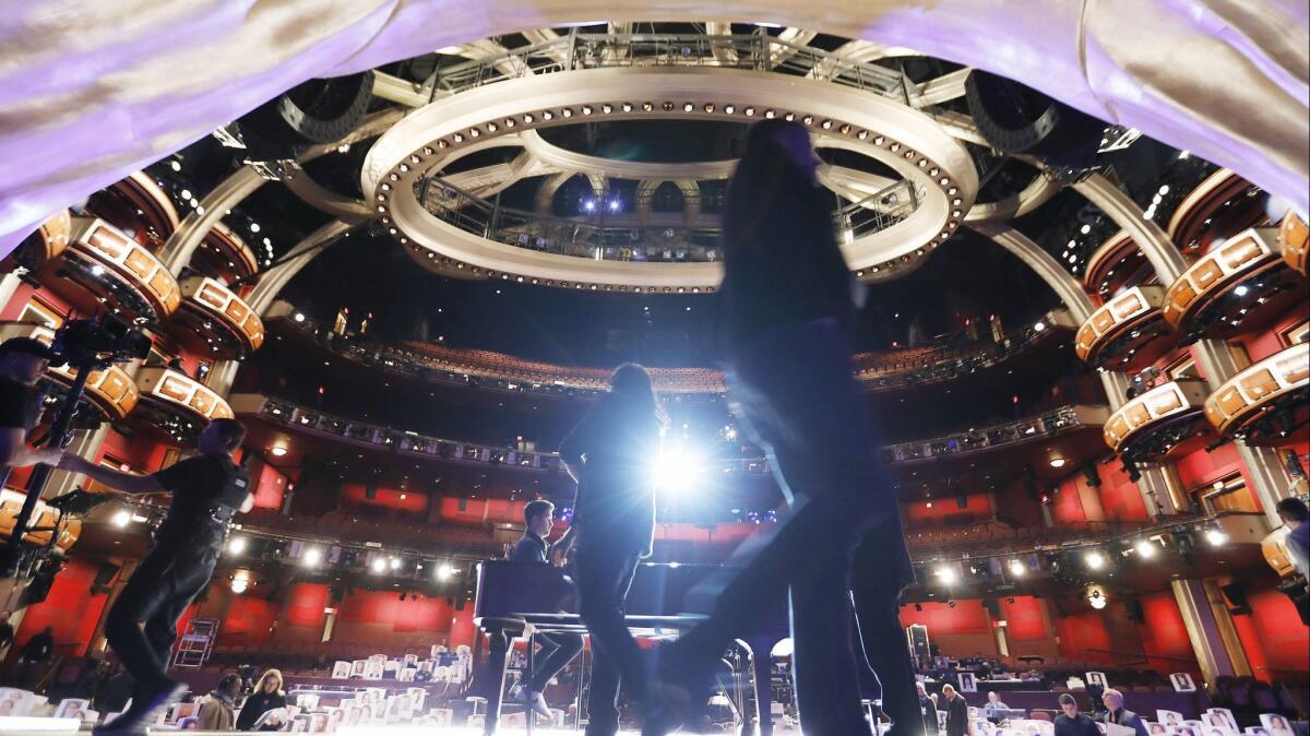 Oscar show director Glenn Weiss, center, works onstage with stage managers and steadicam operators in the Dolby Theatre during rehearsals for the 91st Oscars show Sunday.