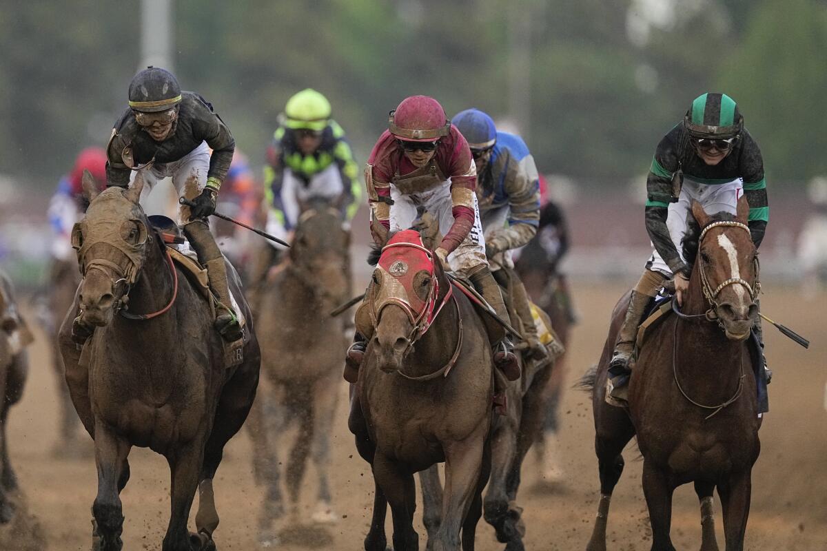 Brian Hernandez Jr. rides Mystik Dan, far right, to victory next to Forever Young, center, and Sierra Leone.