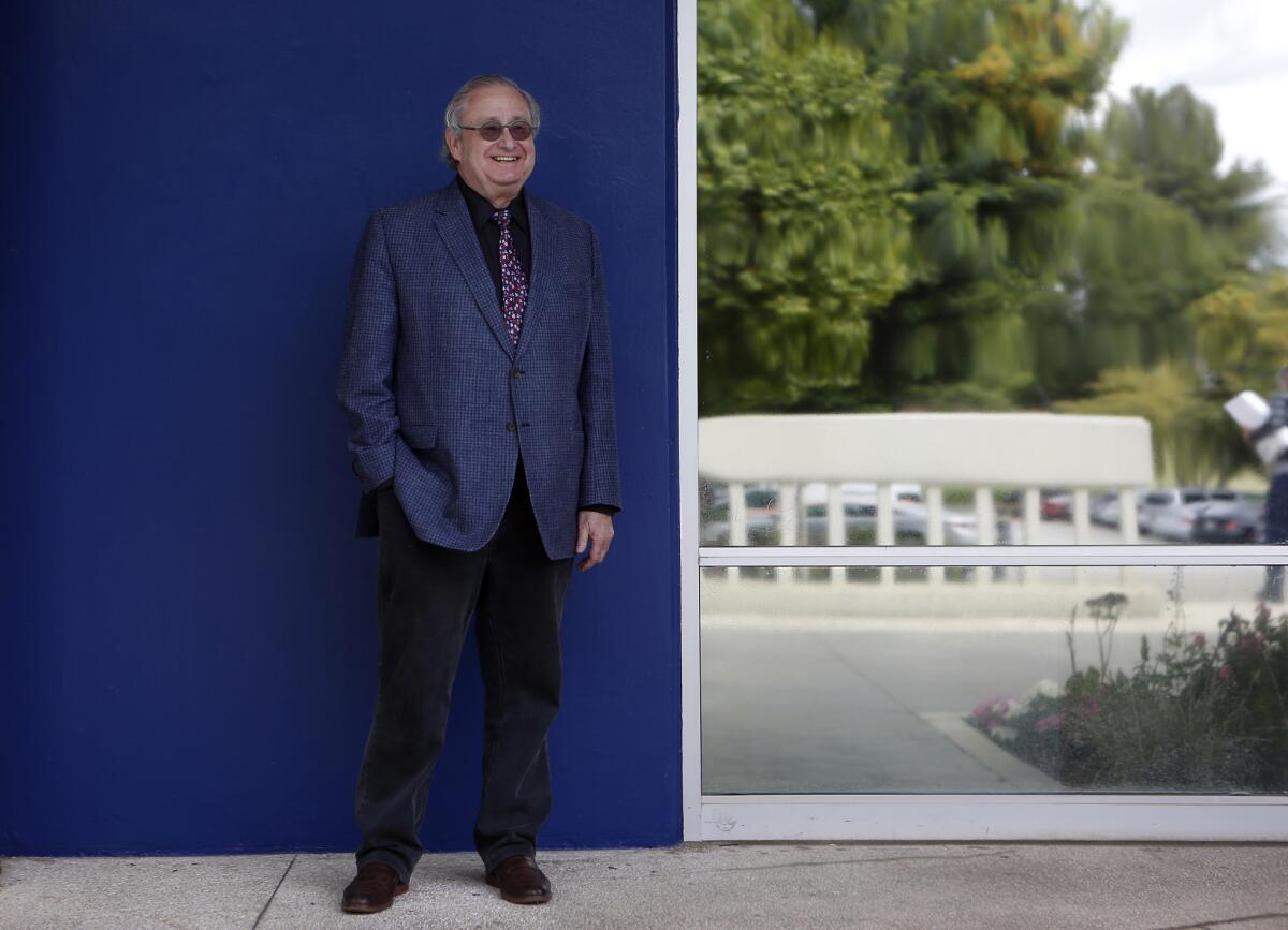 Steven Lavine in his final days as CalArts' third president — standing before the main building of the campus. (Francine Orr / Los Angeles Times)