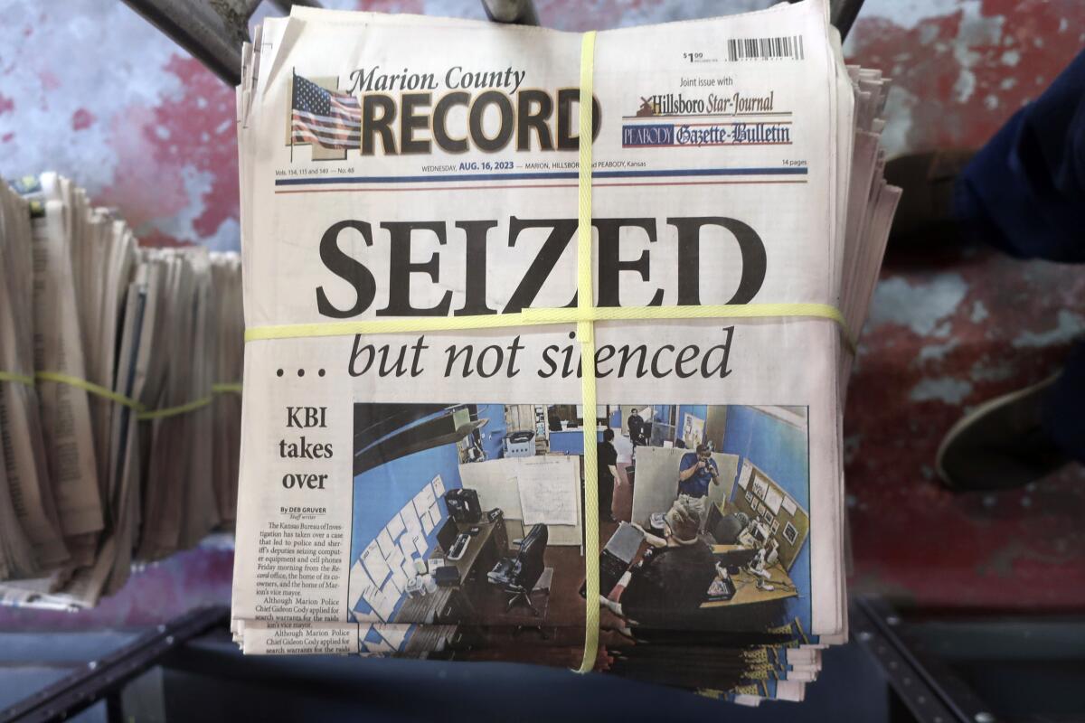 A bundled stack of the latest Marion County Record, which shows the front page headline "SEIZED," in all capital letters. 