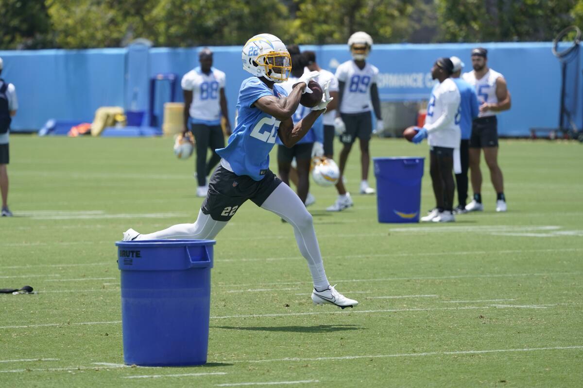  Chargers safety JT Woods makes a catch during practice.