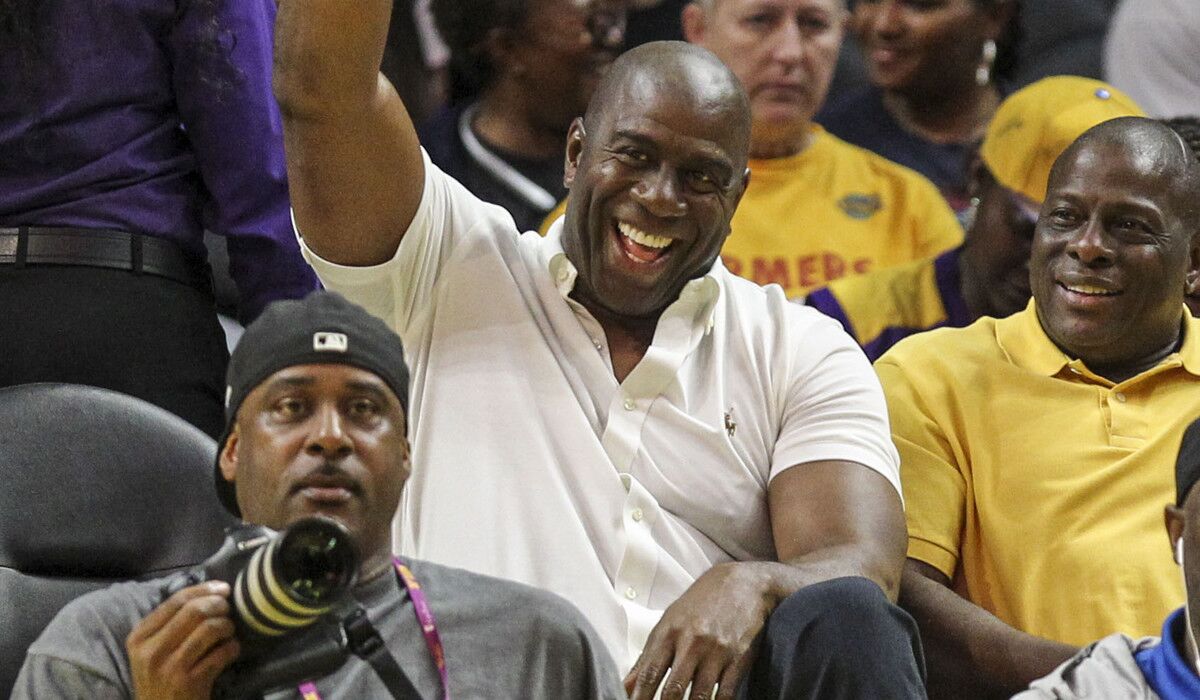 Sparks co-owner Magic Johnson waves during Game 2 of the WNBA semifinal series between the Sparks and the Chicago Sky on Sept. 30, 2016.