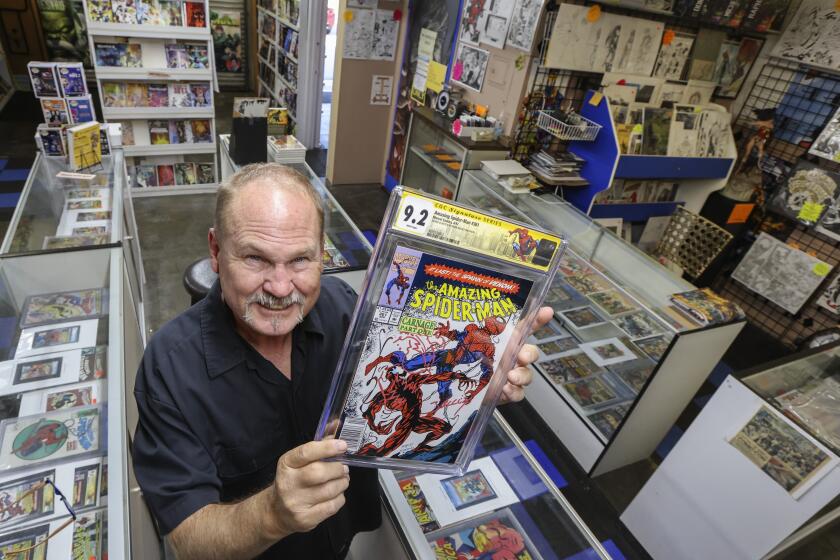 SAN DIEGO, CA - NOVEMBER 05: Shop owner Jamie Newbold holds up an Amazing Spiderman #361 featuring Carnage from the 2nd Venom movie with additional after market art work by comic book artist Mark Bagley valued at over $700 at Southern CA Comics on Friday, Nov. 5, 2021 in San Diego, CA. (Eduardo Contreras / The San Diego Union-Tribune)