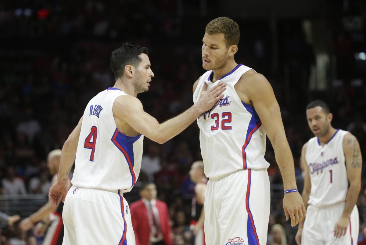 J.J. Redick, left, encourages Blake Griffin, who played through flu-like symptoms Nov. 8 during the Clippers' victory over Portland.