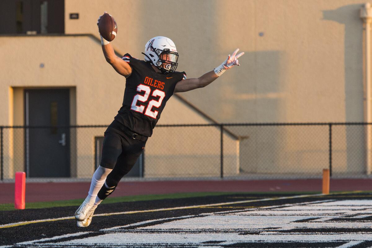 Huntington Beach's Luke Adelman celebrates after scoring a touchdown against Henderson (Nev.) Green Valley in a season opener at Cap Sheue Field on Aug. 23.