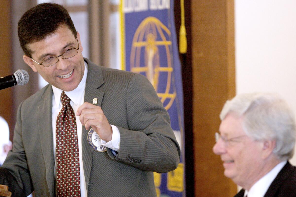 City manager Mark Alexander, left, speaks about Donald Voss, right, who was named the 2015 La Cañadan of the Year at the Kiwanis Club of La Cañada Award Luncheon at Descanso Gardens on Wednesday, May 4, 2016.