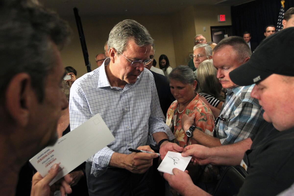 Republican presidential candidate Jeb Bush signs autographs after speaking at a campaign stop, Wednesday, Aug. 12, 2015, in Reno, Nev. (AP Photo/Lance Iversen)