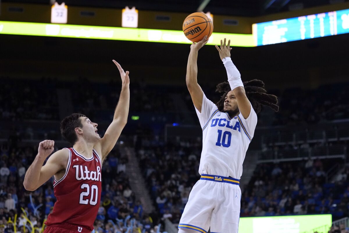 UCLA guard Tyger Campbell shoots over Utah guard Lazar Stefanovic.