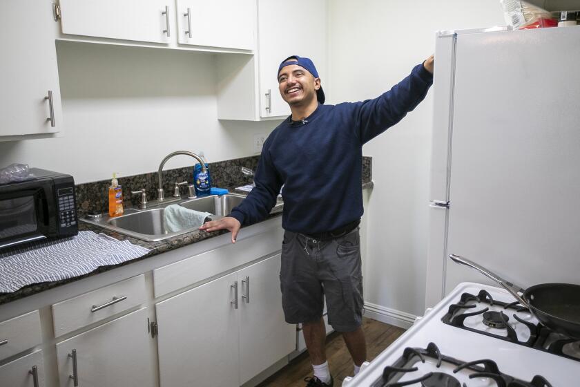 Christian, 22, a former foster youth gives a tour of his new apartment in Tustin on Thursday, December 19. Christian is a recipient of a housing assistance initiative launched this year by U.S. Housing and Urban Development that provides vouchers to help provide stable housing for young adults aging out of foster care and experiencing homelessness.