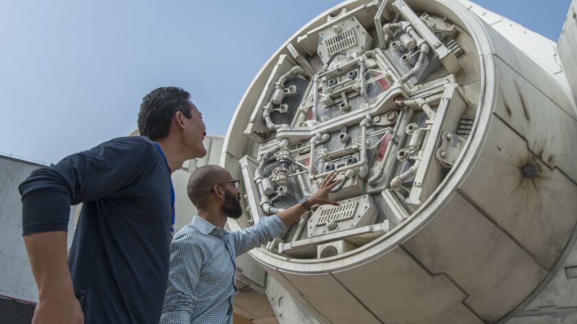 Star Wars: Galaxy's Edge features a full-scale Millennium Falcon. At left is Lucasfilm's Doug Chiang, VP and creative director, with Imagineer Asa Kalama.