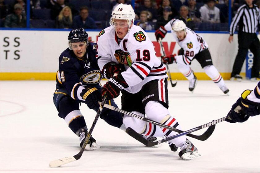 Chicago Blackhawks' Jonathan Toews (19) moves the puck up ice against the St. Louis Blues