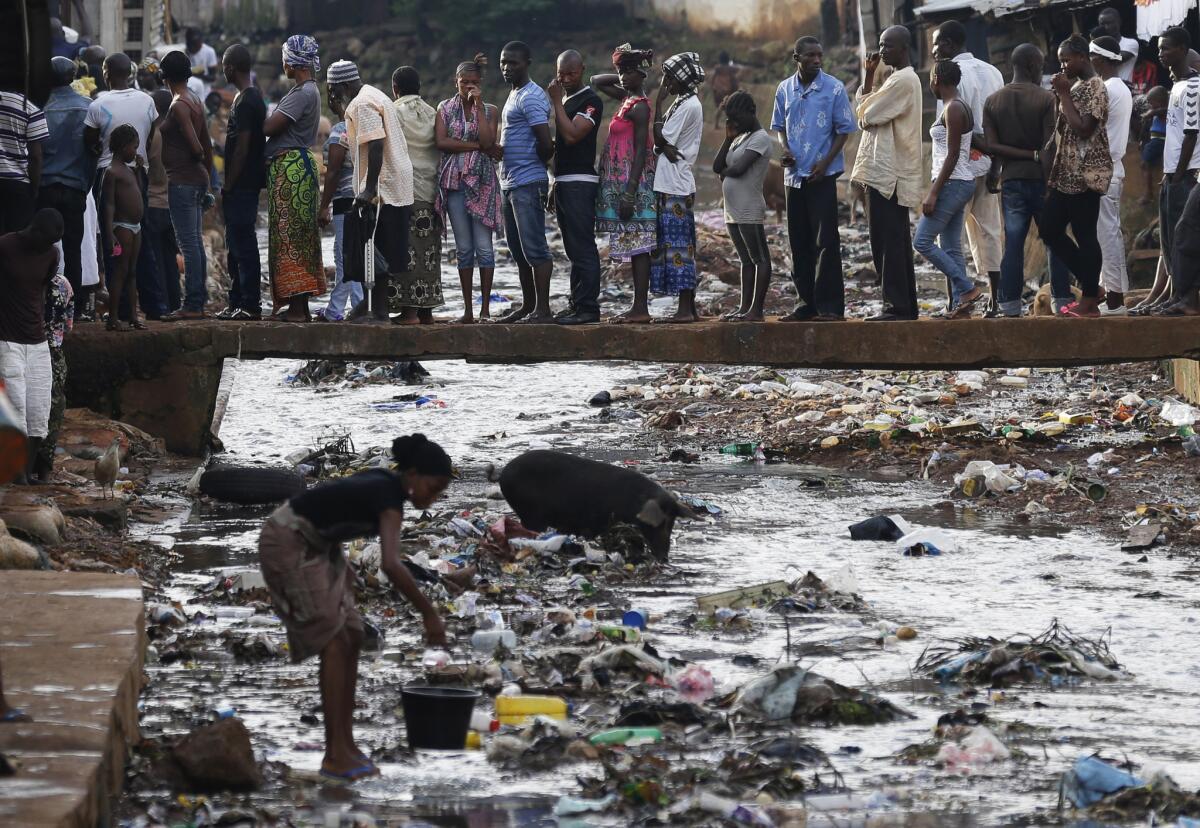 A survey released Wednesday of Africans in 34 countries finds that nearly one-third had been forced to pay bribes over the previous year. Sierra Leoneans, pictured here waiting to vote in Freetown in November 2012, were among the most critical of their leaders' failure to bring about clean governance.