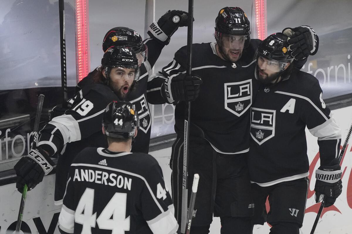 The Kings' Alex Iafallo (19) celebrates his goal with teammates during the first period March 19, 2021.