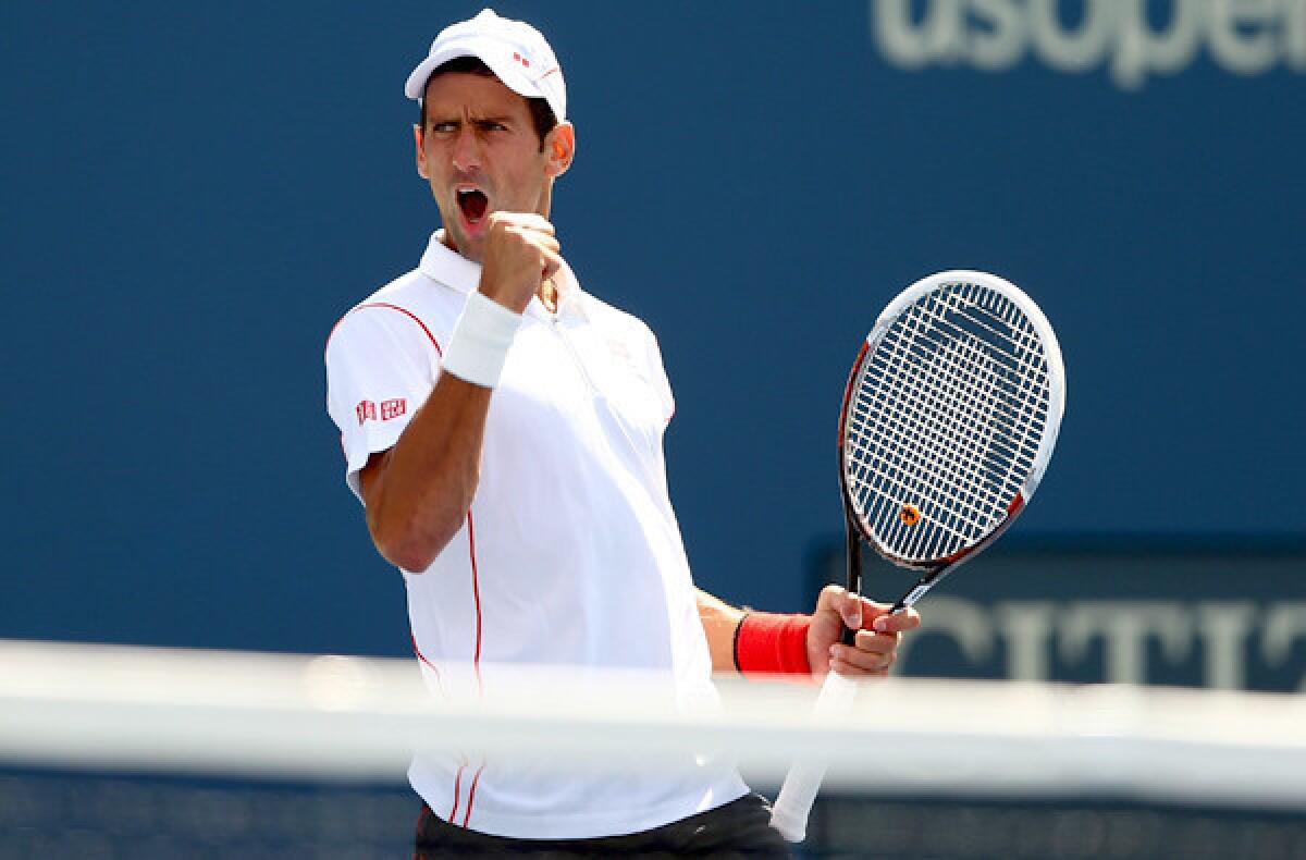Novak Djokovic celebrates after winning the second set against Stanislas Wawrinka in the semifinals of the U.S. Open on Saturday.