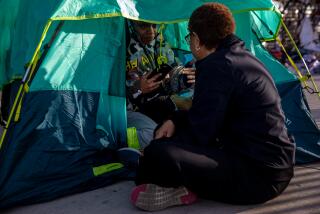 Los Angeles, CA - February 16: Mayor Karen Bass, left, chats with Jawonna Smith, 33, who lives in a tent on sidewalk behind Academy Museum of Motion Pictures, before she was moved to a motel under "Inside Safe" program on Thursday, Feb. 16, 2023 in Los Angeles, CA. (Irfan Khan / Los Angeles Times)