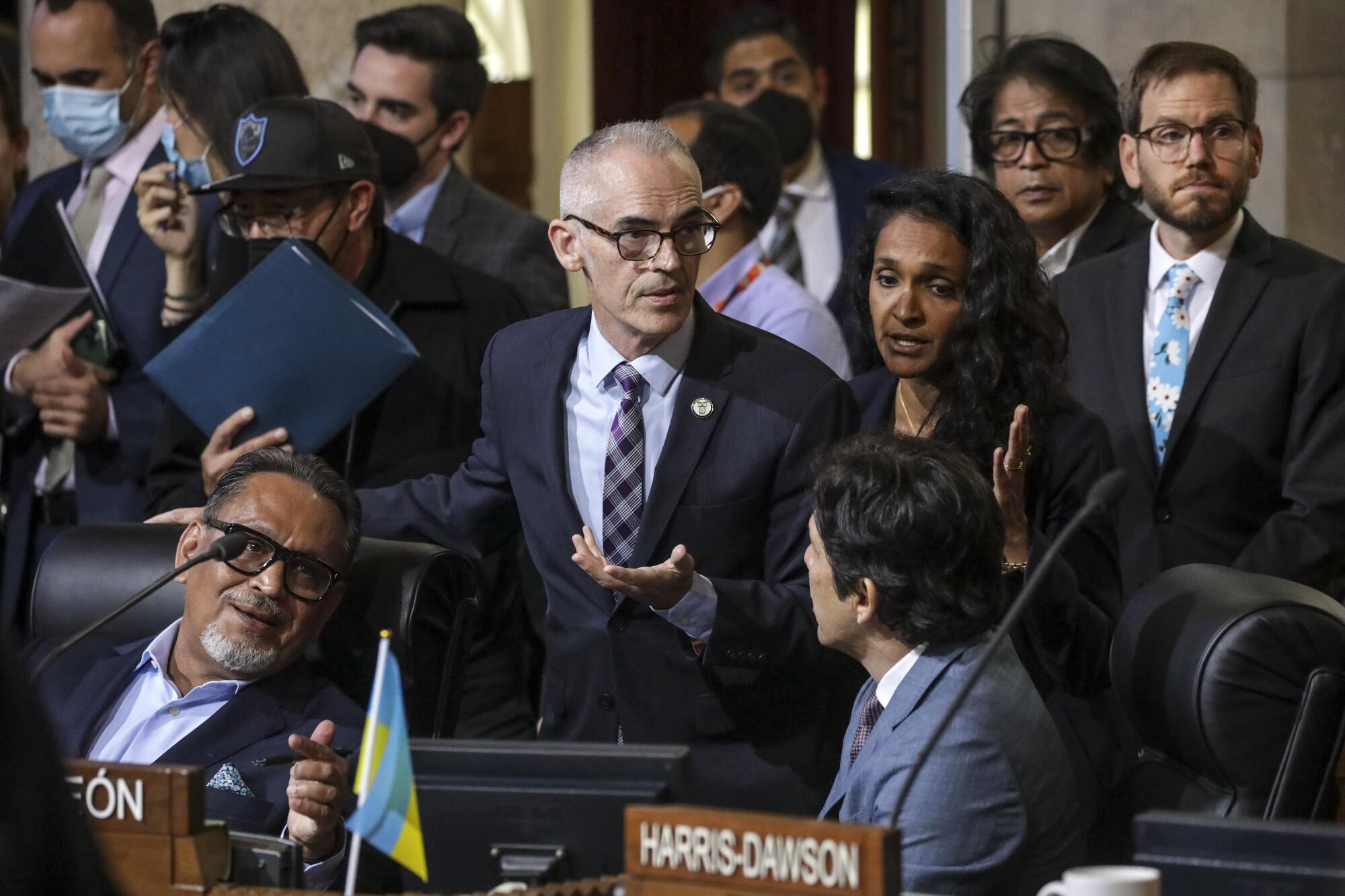 Mitch O'Farrell, center, and Councilwoman Nithya Raman talk to council members Gil Cedillo, left, and Kevin de Leon 