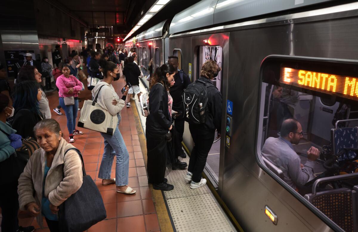 Passengers prepare to ride the Metro E Line in downtown Los Angeles on May 15. 
