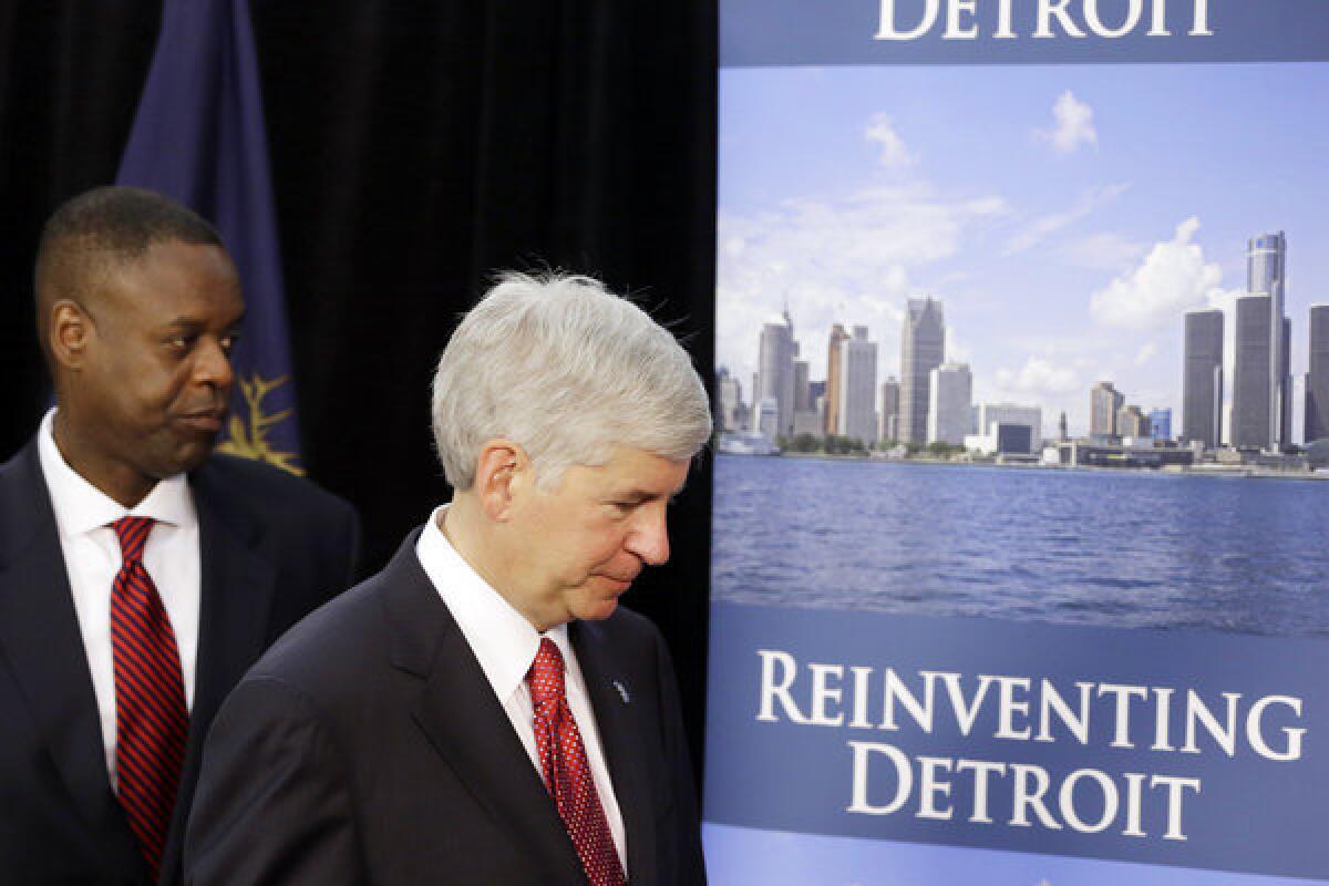 Michigan Gov. Rick Snyder, right, and state-appointed emergency manager Kevyn Orr leave a news conference in Detroit after addressing the city's bankruptcy.
