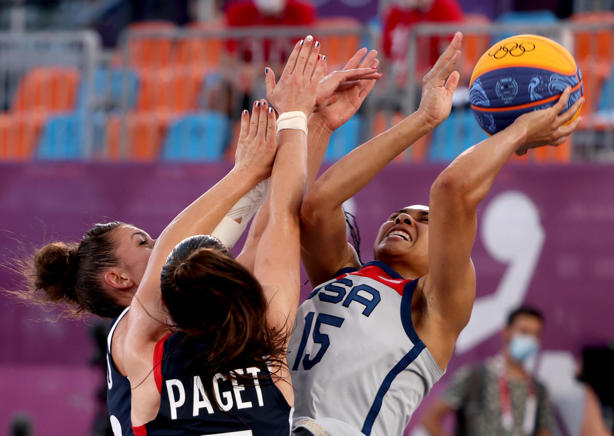 USA's Allisha Gray (15) shoots over Team France Marie-Eve Paget and Ana Maria Filip (11).