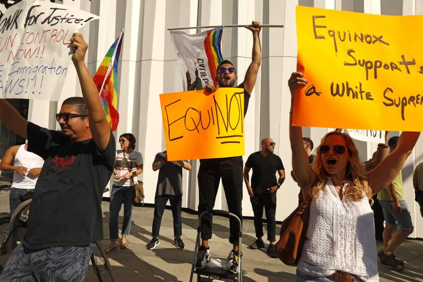 WEST HOLLYWOOD, CA - AUGUST 9, 2019 - - People protest near an Equinox fitness club along Sunset Blvd. in response to club owner Stephen RossÕ fundraiser on behalf of President Donald Trump in West Hollywood on August 9, 2019. Ross, founder and chairman of the Related Cos., parent company of Equinox and SoulCycle, is hosting an event to benefit TrumpÕs re-election campaign at the same time the protest is happening. Close to 50 people participated in the protest. (Genaro Molina / Los Angeles Times)