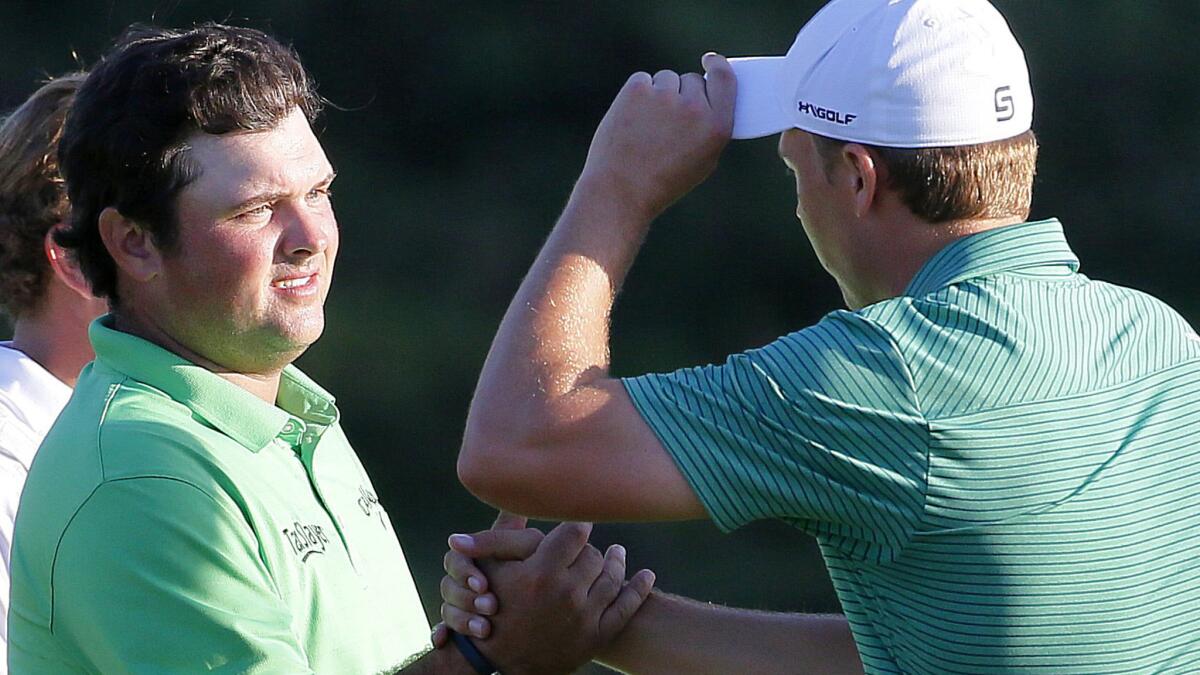 Patrick Reed, left, congratulates Jordan Spieth after the first round of the Tournament of Champions golf tournament Thursday.