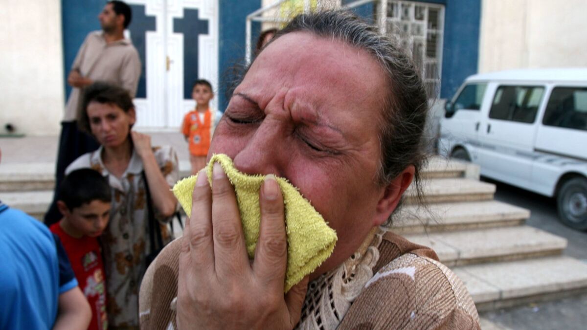 An Iraqi Christian woman cries outside a church in Baghdad Jadidah in Baghdad, Iraq on June 10, 2007.
