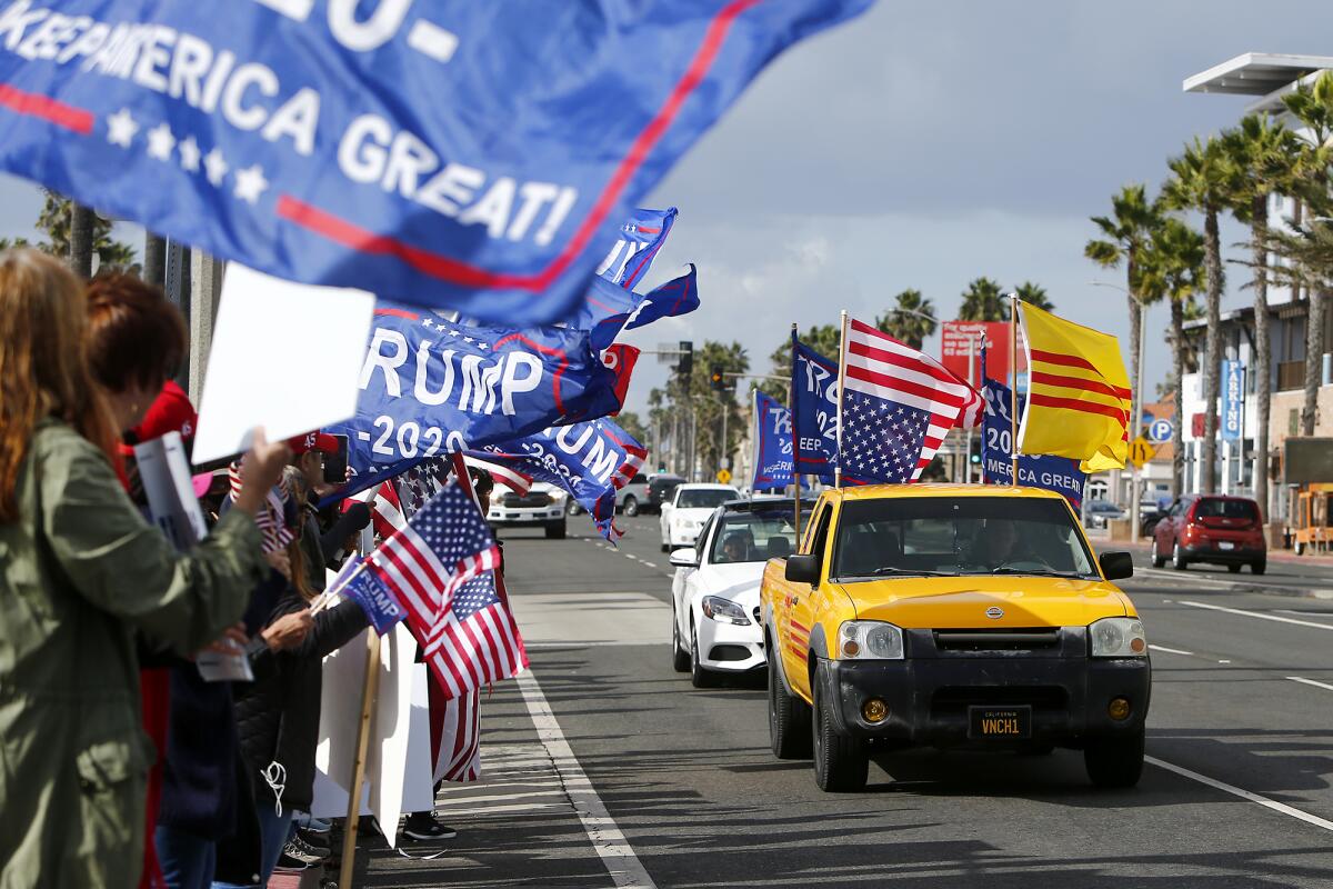 Pro-Trump protesters rally Saturday afternoon at Pier Plaza in downtown Huntington Beach.