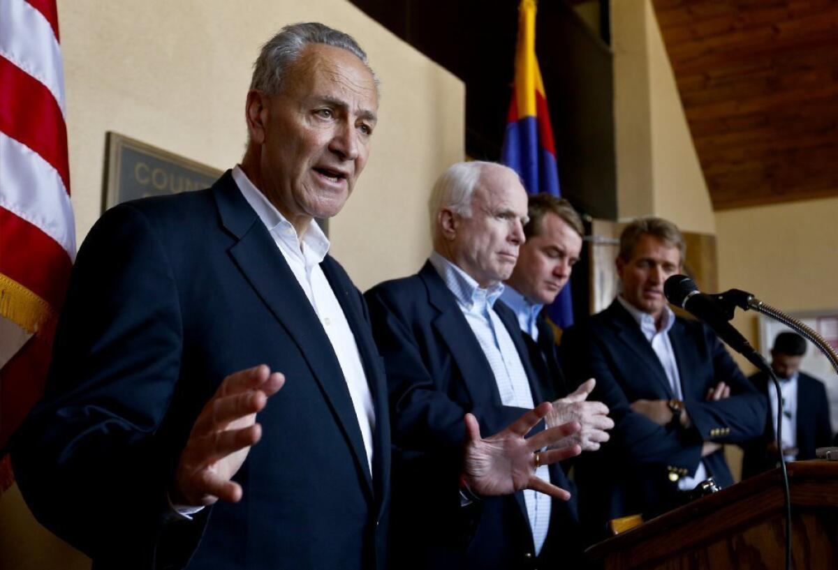 Sen. Chuck Schumer, seen here with other U.S. senators working on an immigration reform package, has been brokering talks between the AFL-CIO and the U.S. Chamber of Commerce on a guest-worker program.