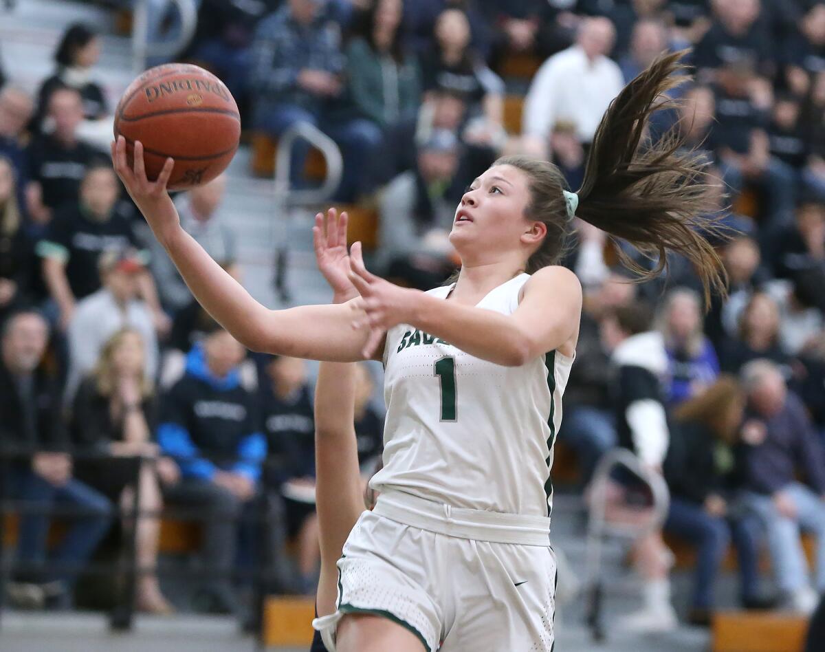 Sage Hill’s Emily Elliott drives in for a layup against St. Margaret's in a San Joaquin League game on Tuesday in Newport Beach.