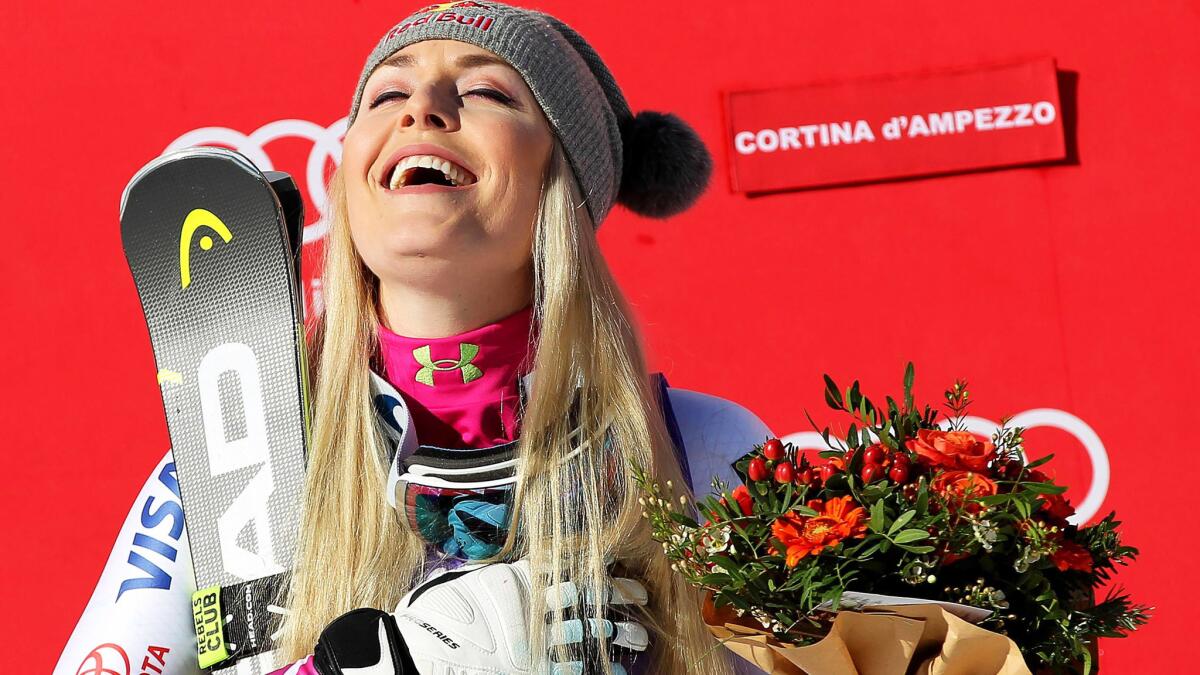 Lindsey Vonn rejoices on the podium after winning a World Cup downhill race in Cortina d'Ampezzo, Italy, on Saturday.
