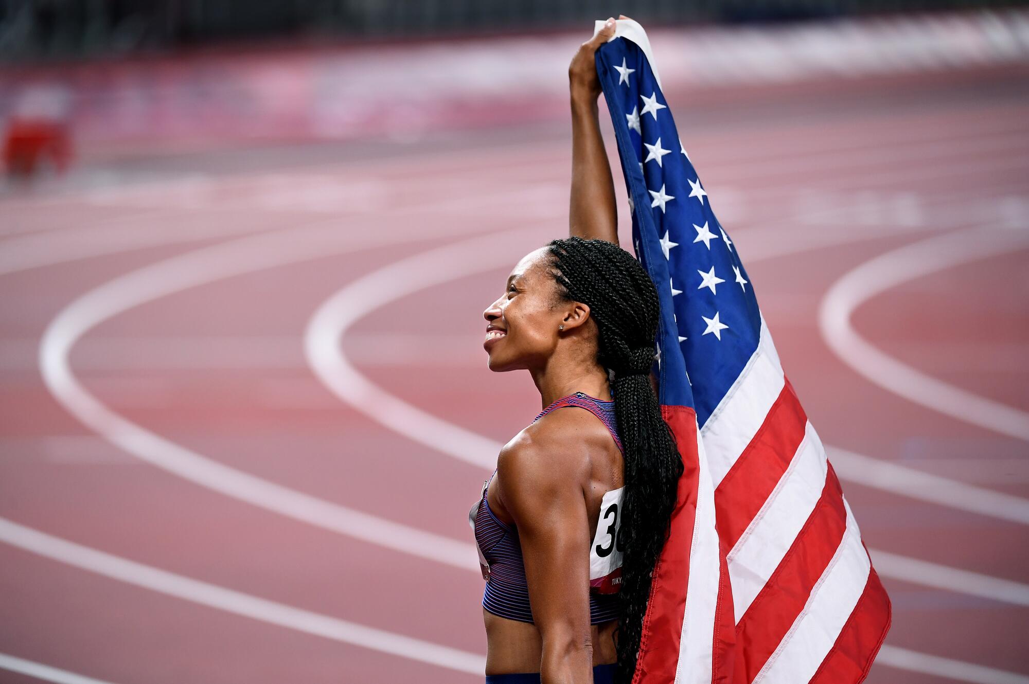 USA's Allyson Felix holds up the American flag
