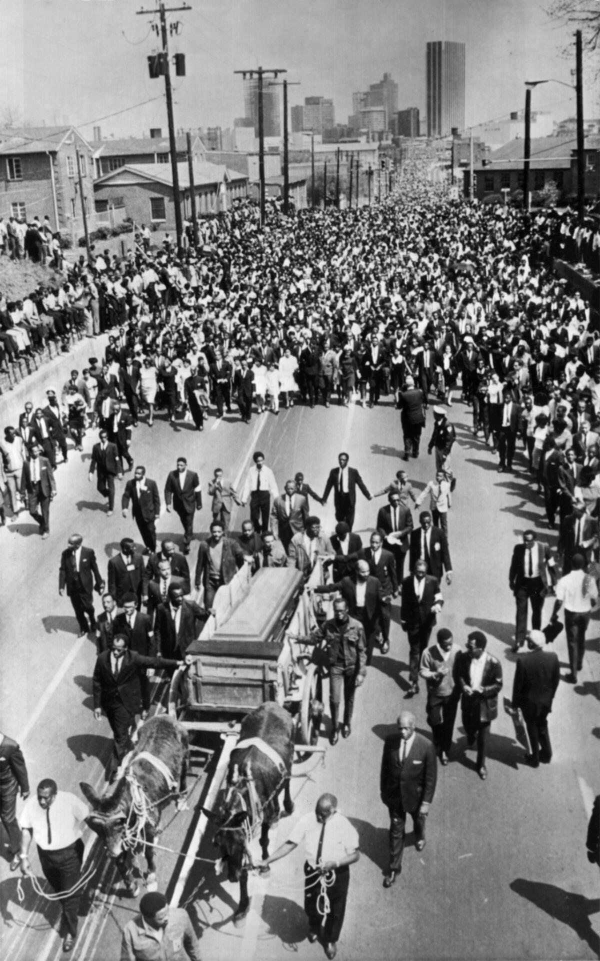 Dr. Martin Luther King met death at the hands of an assassin in 1968. His funeral procession through the streets of Atlanta drew this huge crowd of mourners.